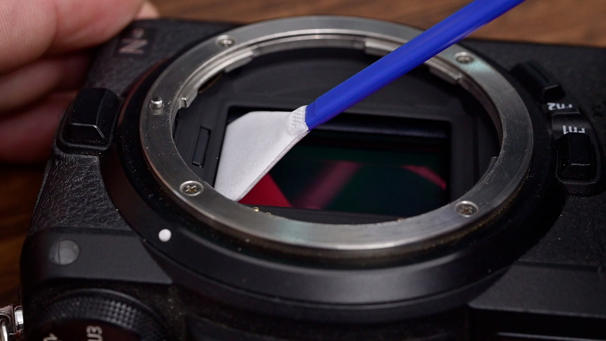 using sensor cleaning swab